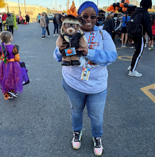 Michelle Moore holding up Fearless Females mascot, Frida, at Central’s Trunk or Treat event.